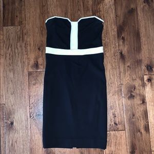 Black and white straight, form-fitting dress.